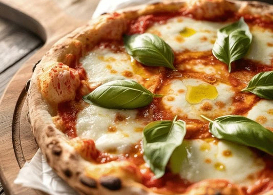 Pizza with cheese, tomato sauce, and basil leaves on a wooden board.